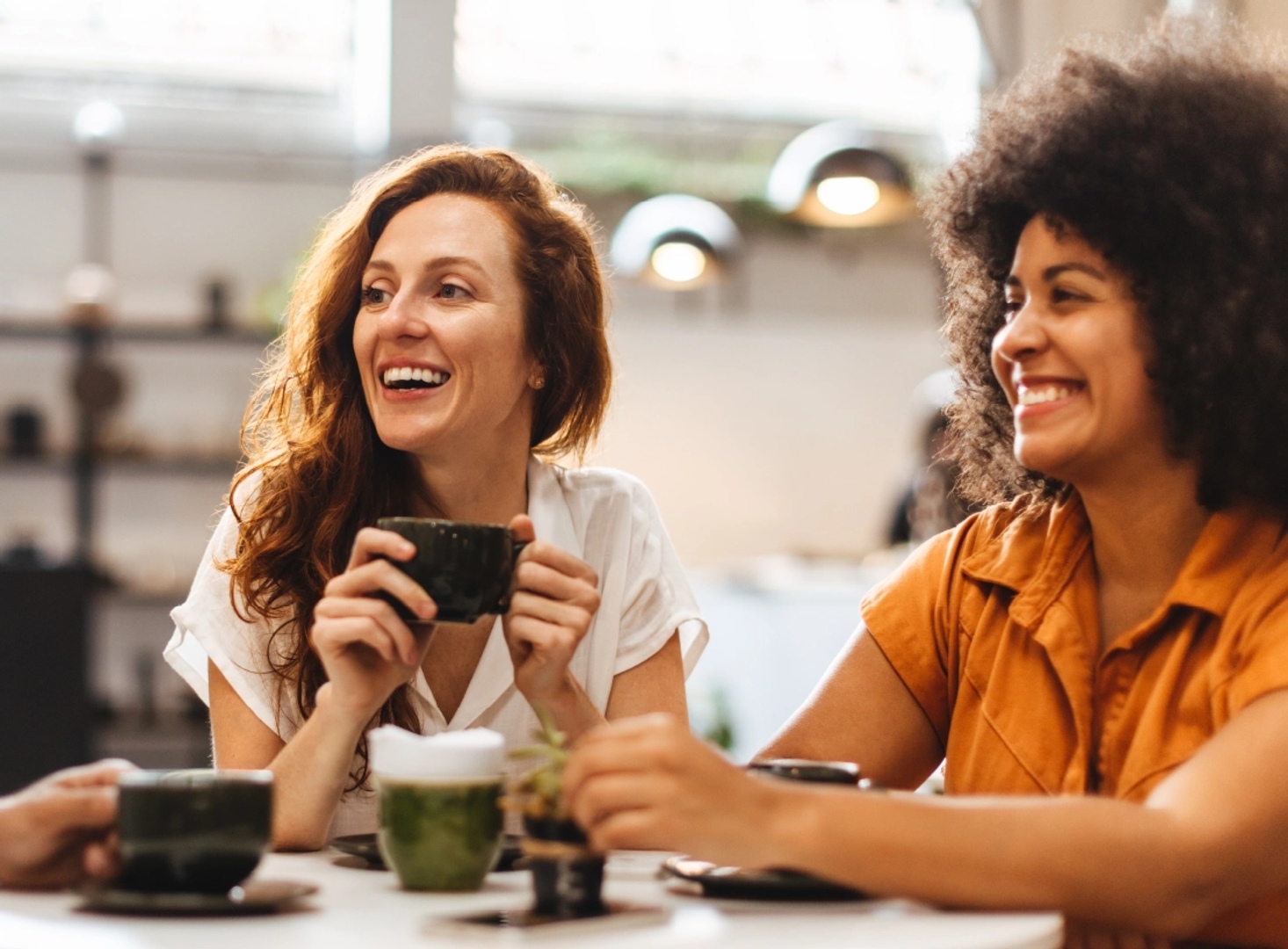 Friends chatting over coffee at Wilton Center